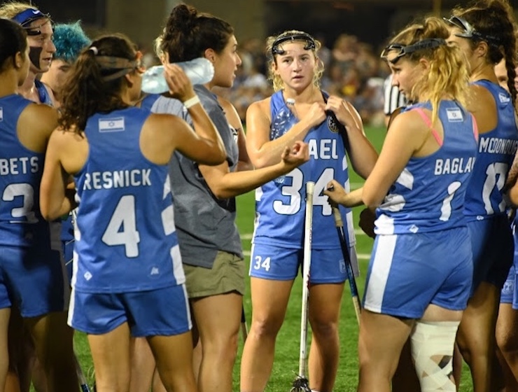 Girls lacrosse players in a huddle