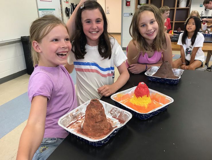 Campers displaying their homemade volcanoes