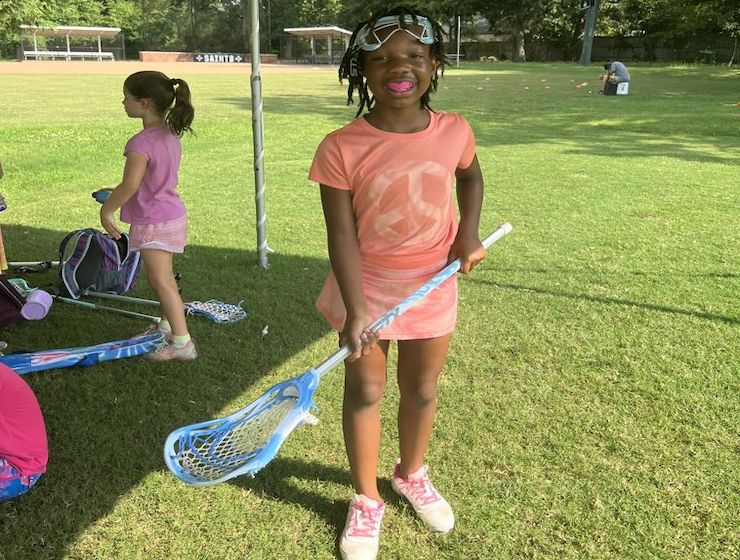 Girl holding a lacrosse stick