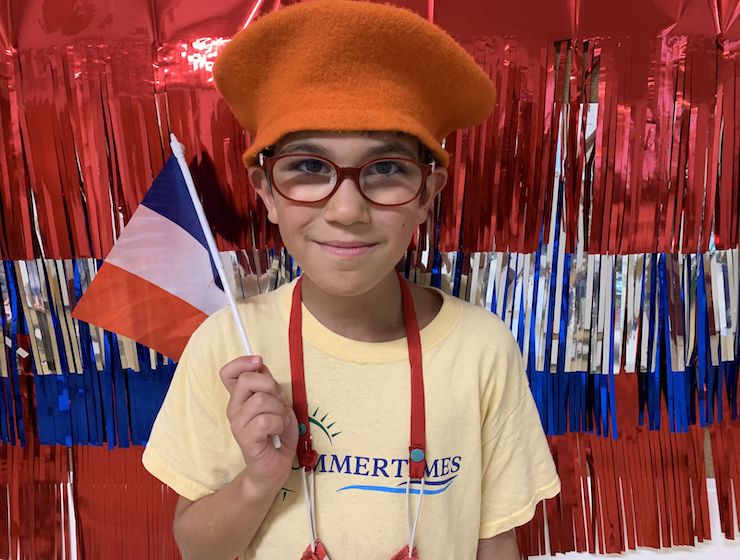 Camper smiling holding the French flag